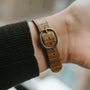 The Patek Philippe Ellipse features a brown leather strap with a metal buckle, shown on a persons wrist.
