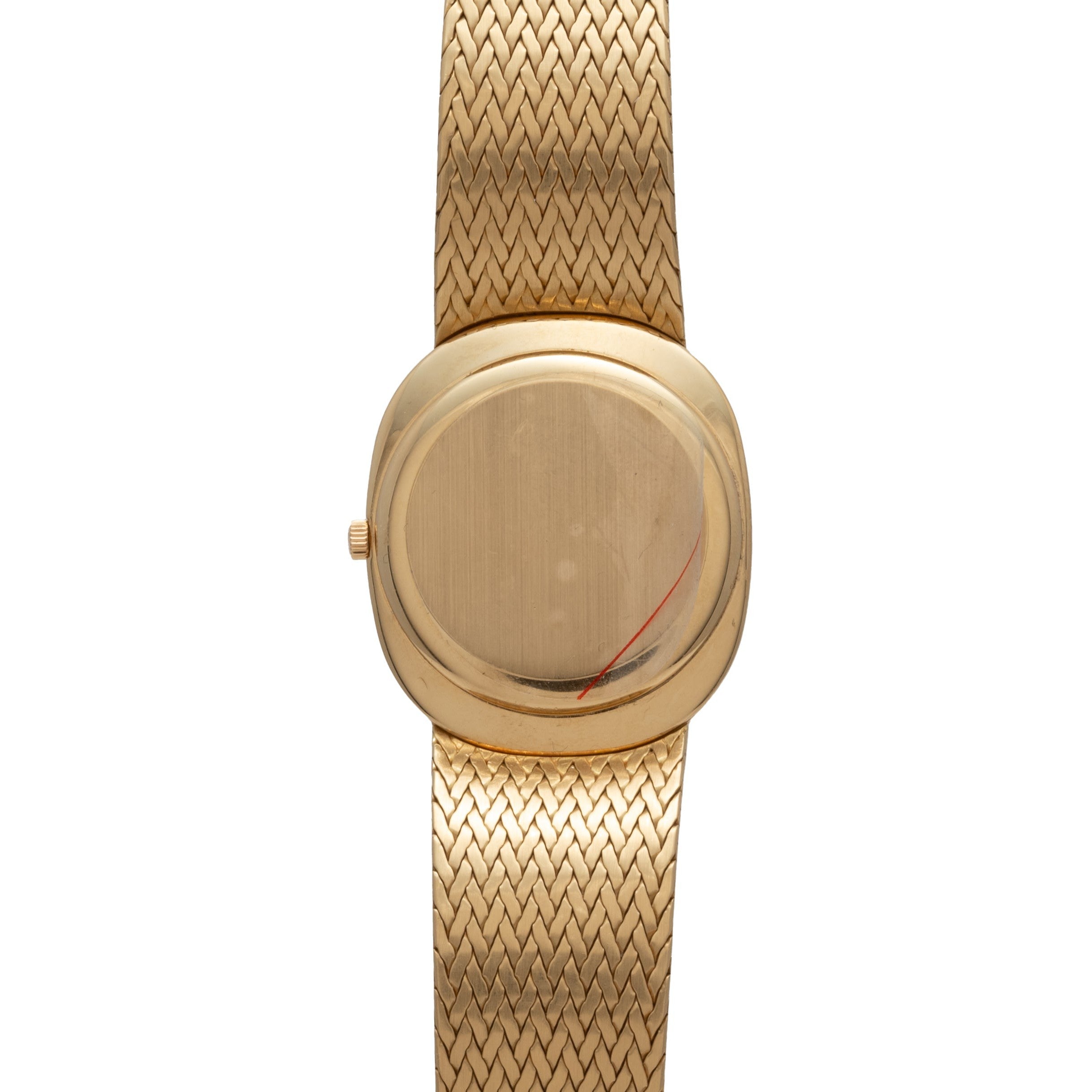 Patek Philippe Ellipse Jumbo gold wristwatch with a blank oval face and woven gold band, photographed from above.