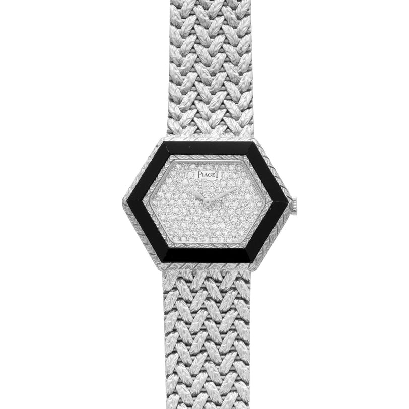 Piaget Hexagonal Diamond Dress Watch featuring a black bezel and woven metallic strap, shown in an overhead view.