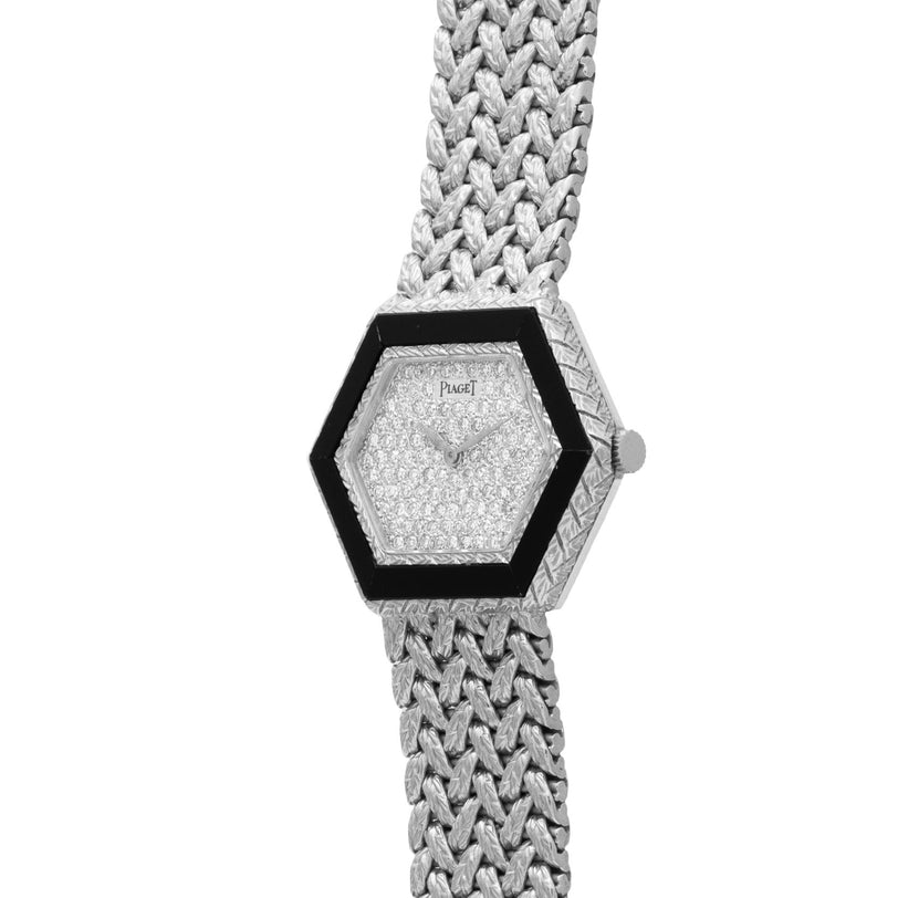 The Piaget Hexagonal Diamond Dress Watch features a silver woven band and a black bezel.