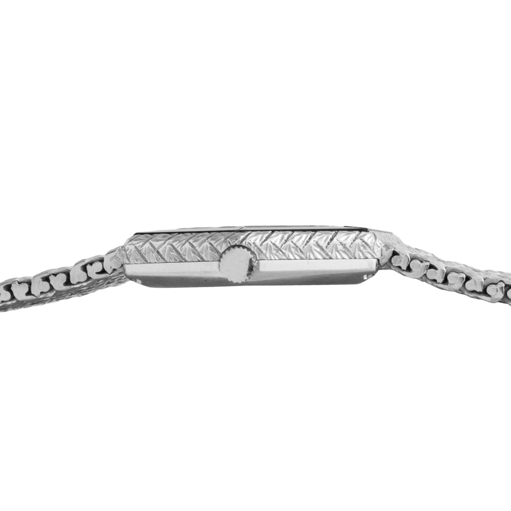 Side view of the Piaget Hexagonal Diamond Dress Watch featuring a silver engraved band and a patterned case.