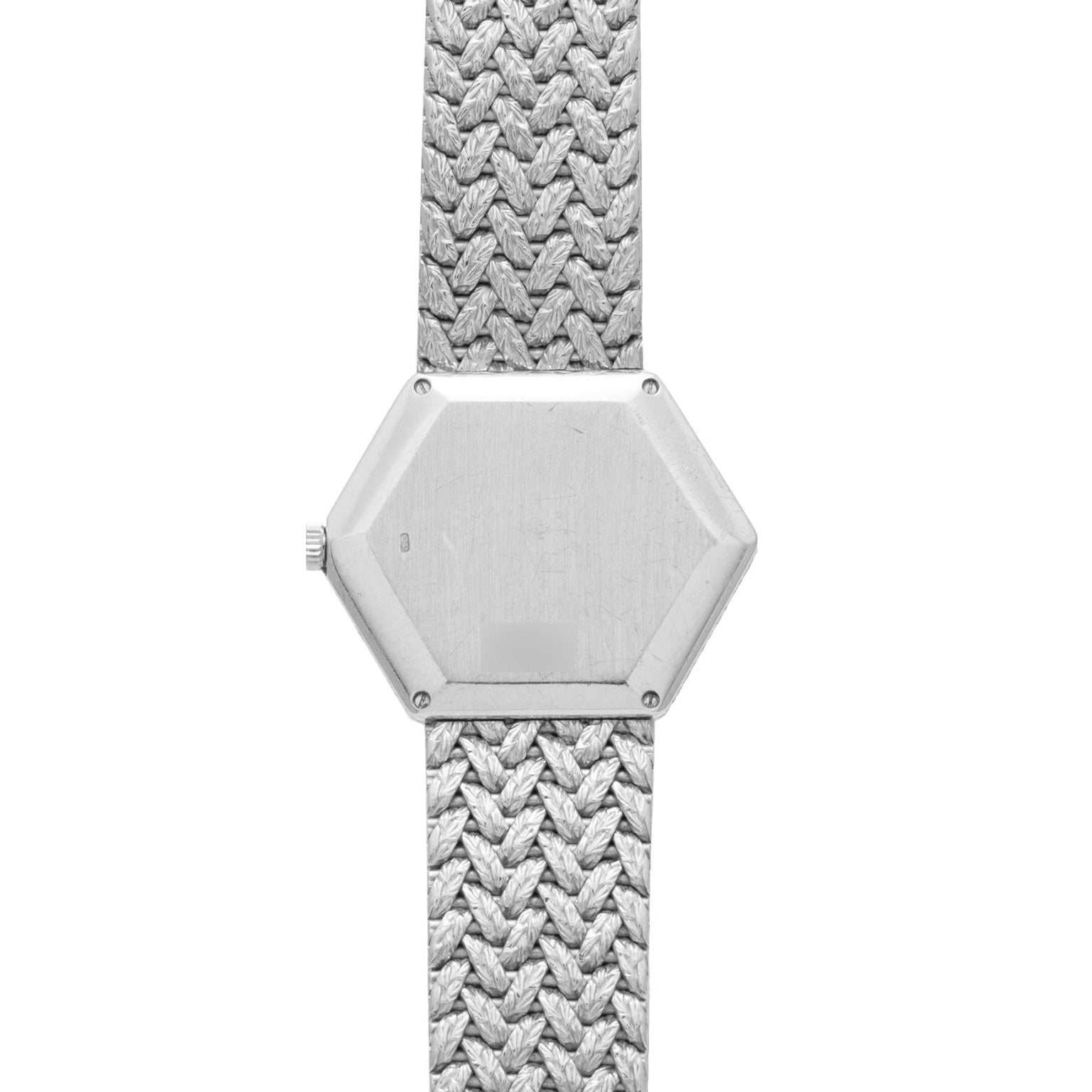 The Piaget Hexagonal Diamond Dress Watch features a silver hexagonal case and textured metal band, displayed without any visible numbers or hands.