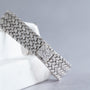 A close-up of the Piaget Hexagonal Diamond Dress Watch featuring a metal clasp engraved with the letter P.