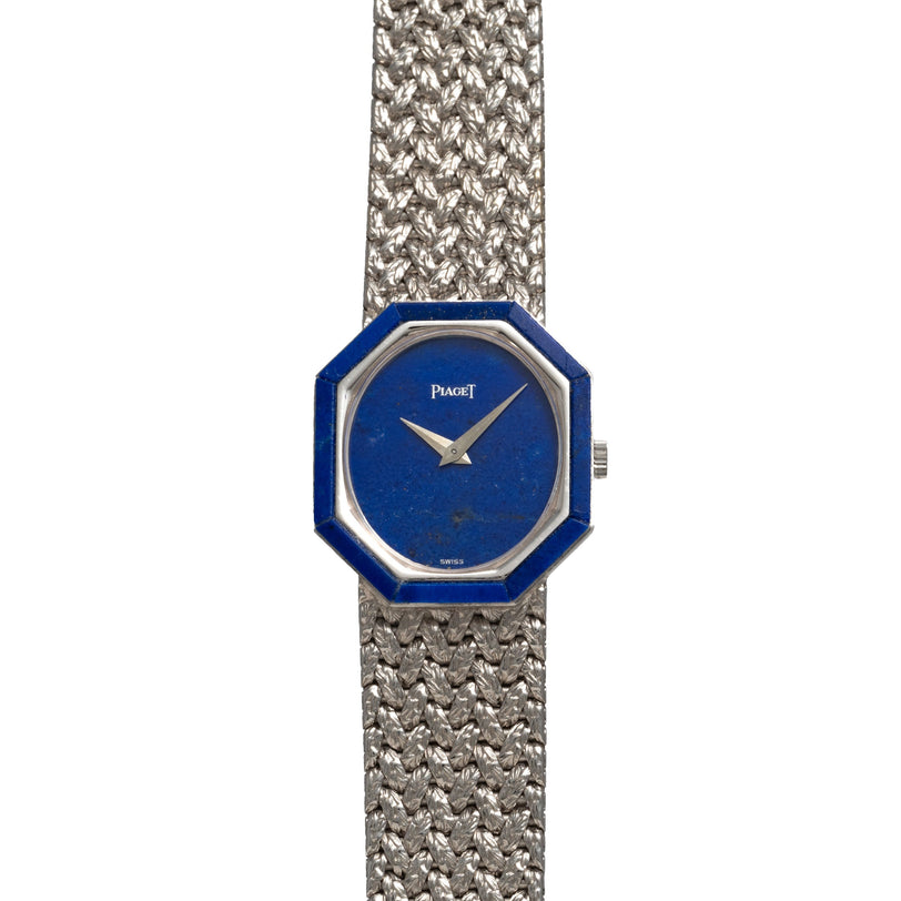 The Piaget Lapis Lazuli White Gold Dress Watch features a striking blue octagonal face and a textured metal band.