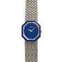 The Piaget Lapis Lazuli White Gold Dress Watch features a striking blue octagonal face and a textured metal band.