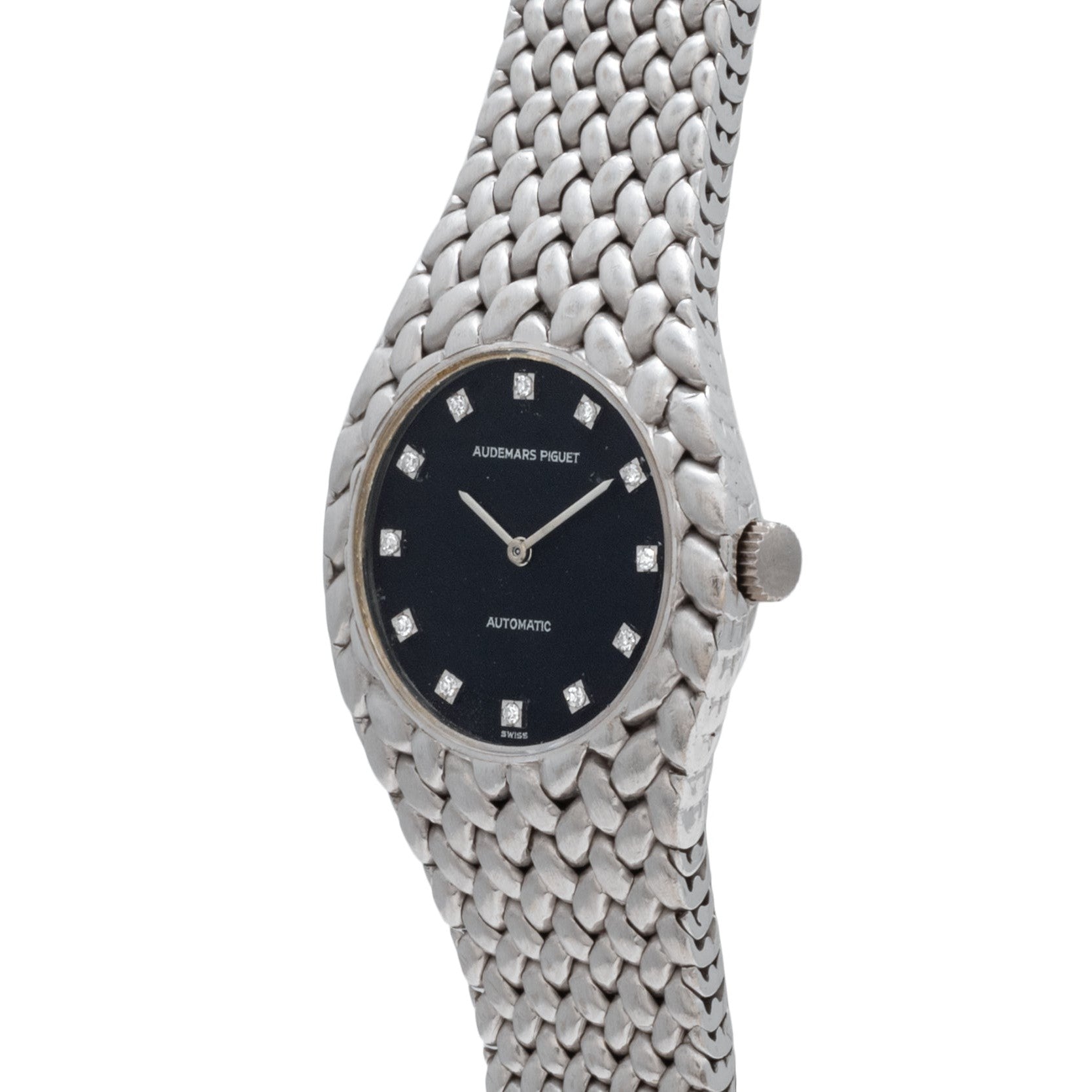 The Audemars Piguet Cobra is a silver wristwatch with a black face, diamond hour markers, and a textured metal band.