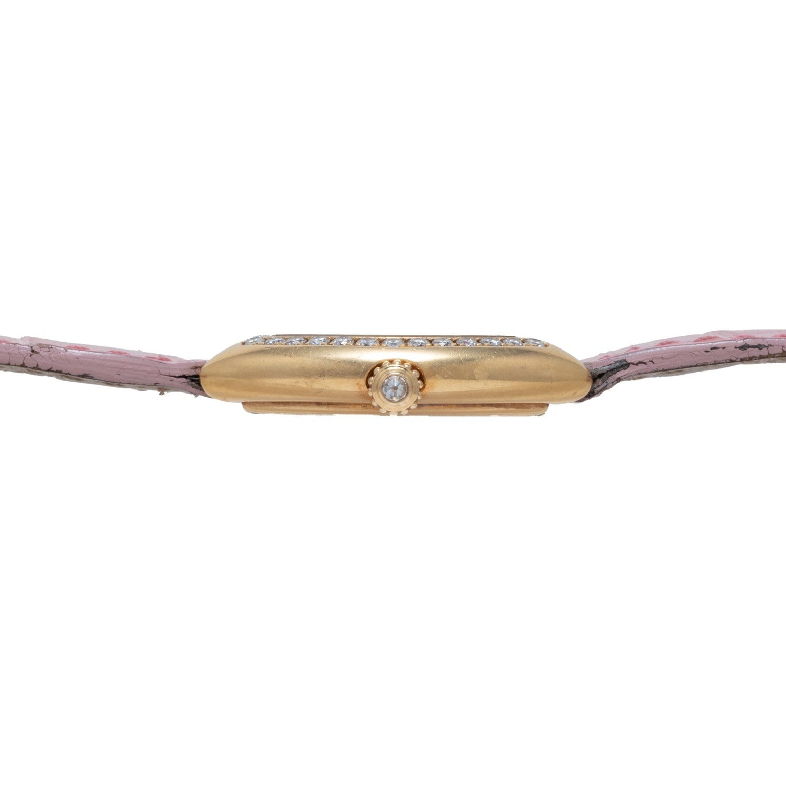 Side view of the Cartier Tortue gold watch case, featuring a diamond crown and a pink leather strap.