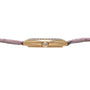 Side view of the Cartier Tortue gold watch case, featuring a diamond crown and a pink leather strap.