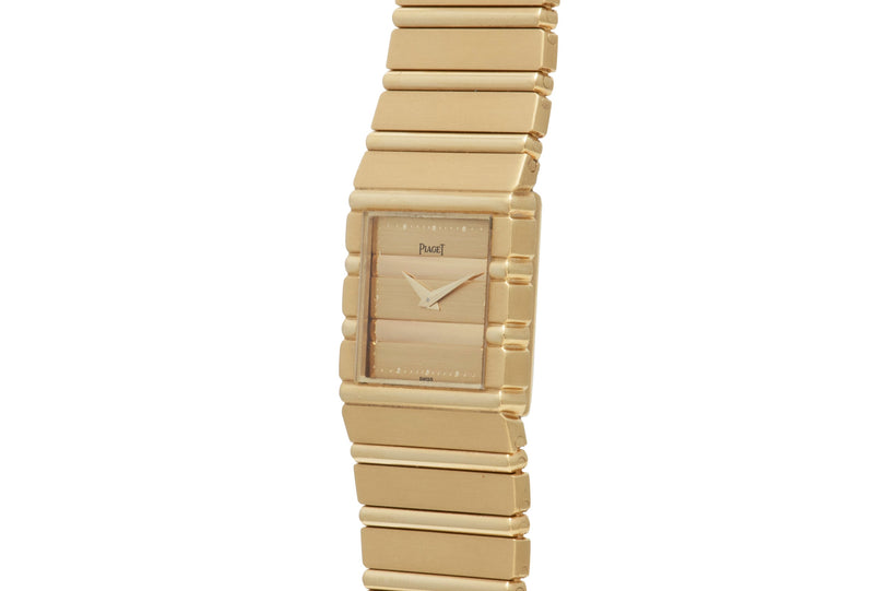 The Piaget Polo is a gold rectangular wristwatch featuring a matching gold band and minimalist dial without numerals.