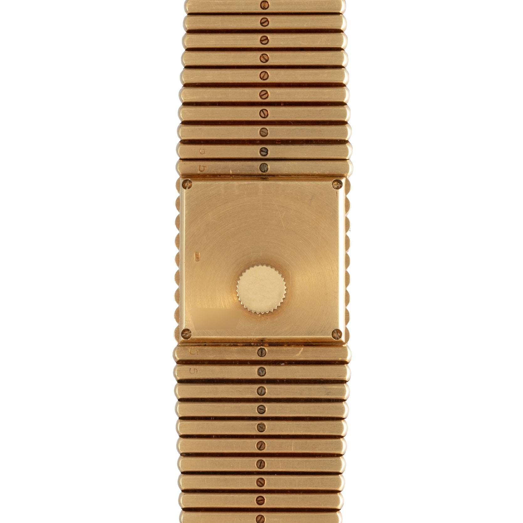 The Piaget Emperador gold watch has a blank square face and a ridged metal band, shown from above.