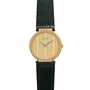 Piaget Polo Large gold wristwatch with a simple round face, black leather strap, and minimal hour markers.