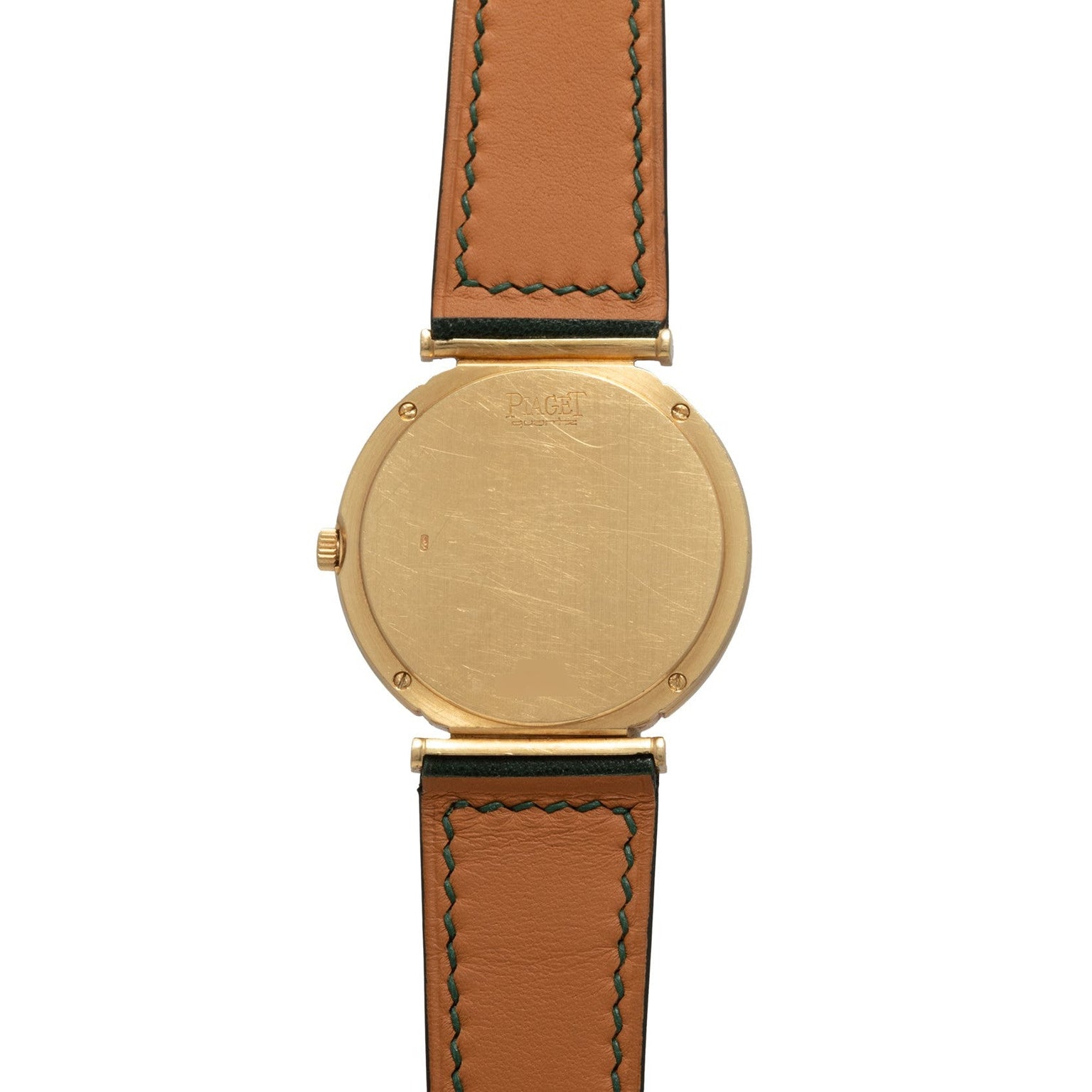 The Piaget Polo Large features a gold wristwatch with a brown leather strap and a plain, unmarked case back, shown from the rear.