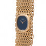 Patek Philippe Ellipse Ladies Woven Cuff watch with a gold case, blue face, and an intricate woven band shown on a white background.