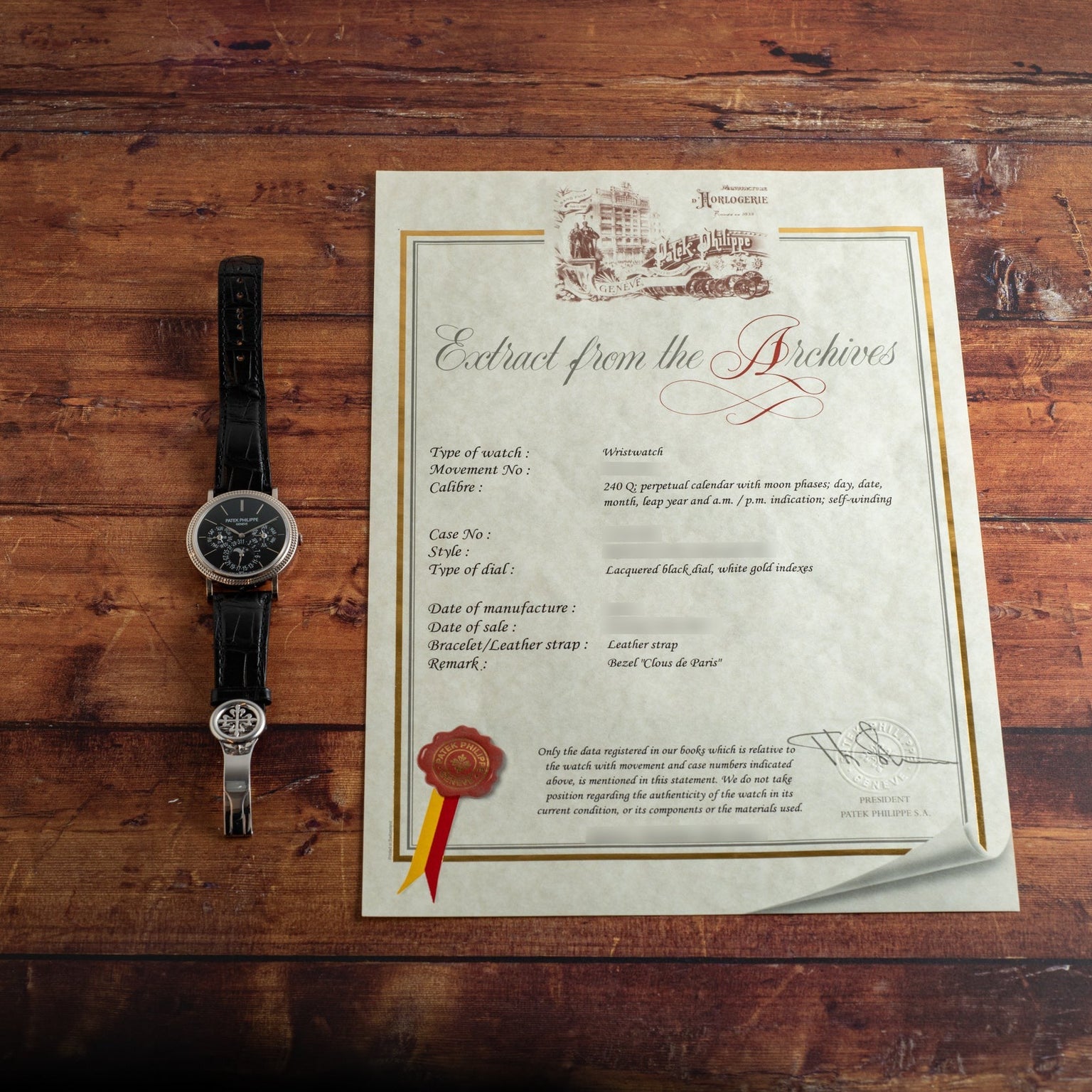 A Patek Philippe Perpetual Calendar Moonphase with a black leather strap rests beside a certificate titled Extract from the Archives.