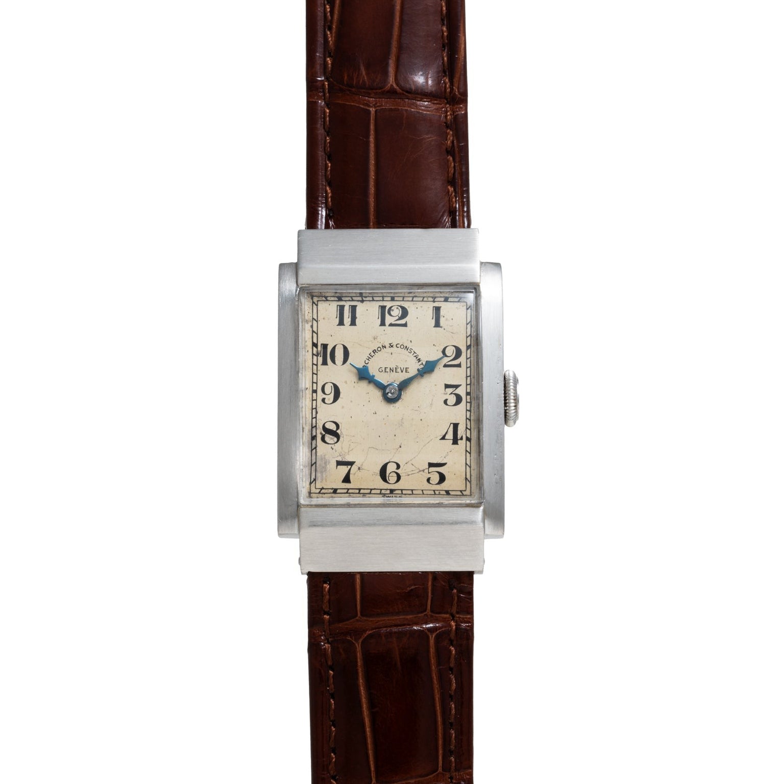 The Vacheron Constantin Rectangular Steel Dress Watch features a vintage look with a brown leather strap and a white dial with black numerals.