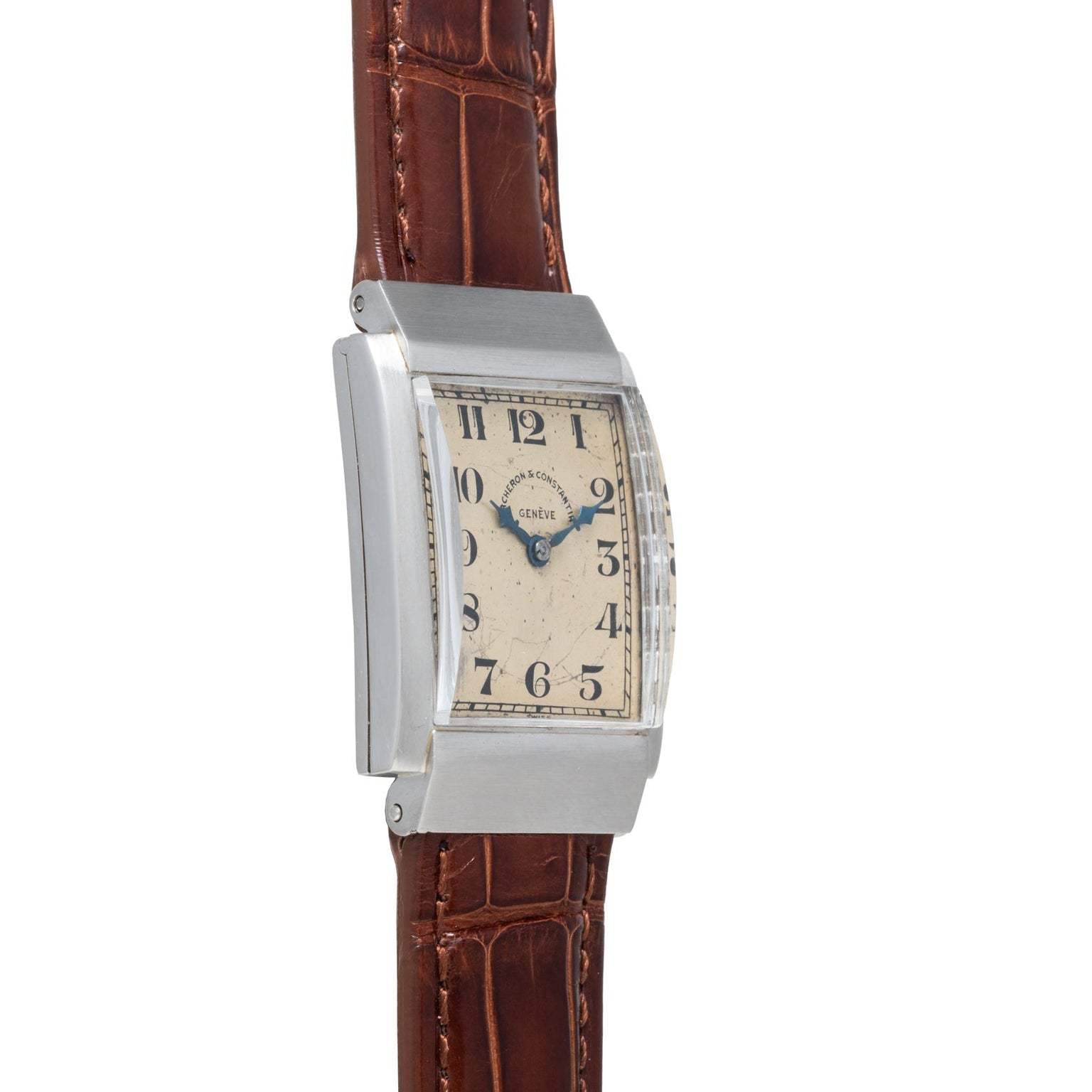 The Vacheron Constantin Rectangular Steel Dress Watch features a brown leather strap and black numerals on a cream dial.