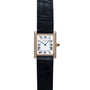 The Cartier Tank Louis watch features a square face with Roman numerals and a black leather strap.