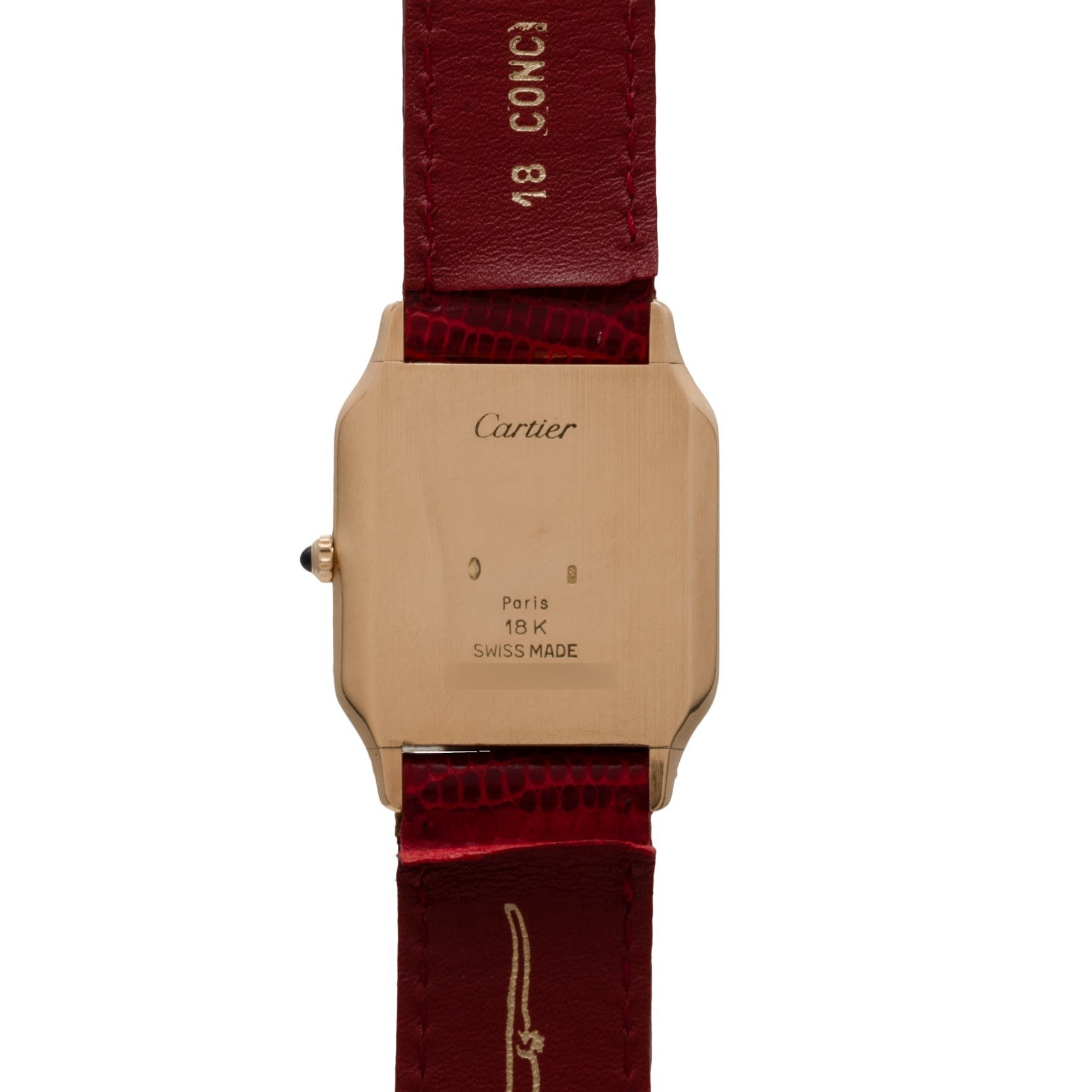Back of a Cartier Santos Dumont wristwatch with a red leather strap and an 18K gold case, marked “Paris” and “Swiss Made.”.