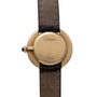 Back of a Cartier Vendome watch with brown leather strap and Cartier Paris engraved on the gold case.