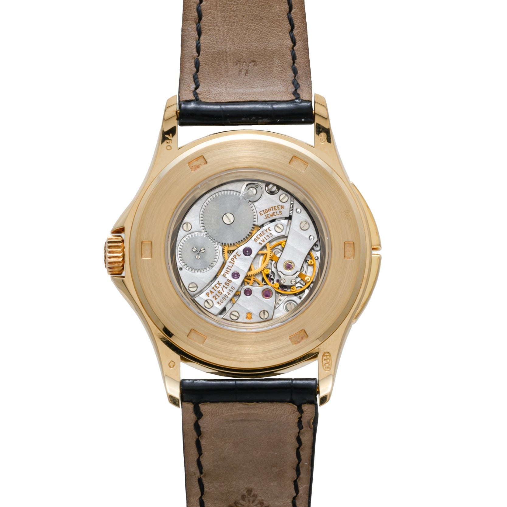The back of the Patek Philippe Calatrava Travel Time showcases exposed mechanical gears and inner workings, complemented by a leather band.