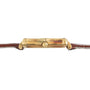 Side view of the Piaget Bamboo Dress Watch featuring a gold case, brown leather strap, and a central round crown.