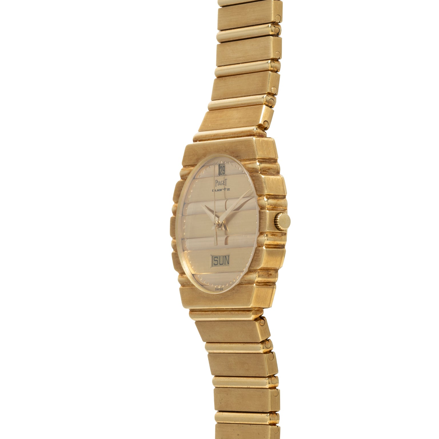 The Piaget Polo Calendar is a gold wristwatch with a rectangular face that shows the time and date, displayed against a white background.