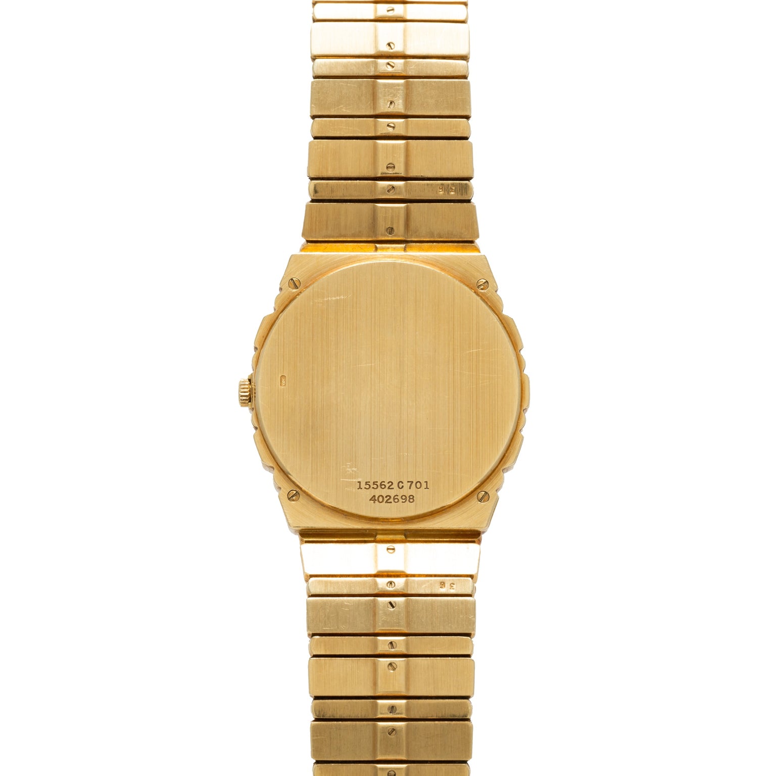 Piaget Polo Calendar watch with a brushed metal finish, viewed from the back, displaying serial numbers on the case.