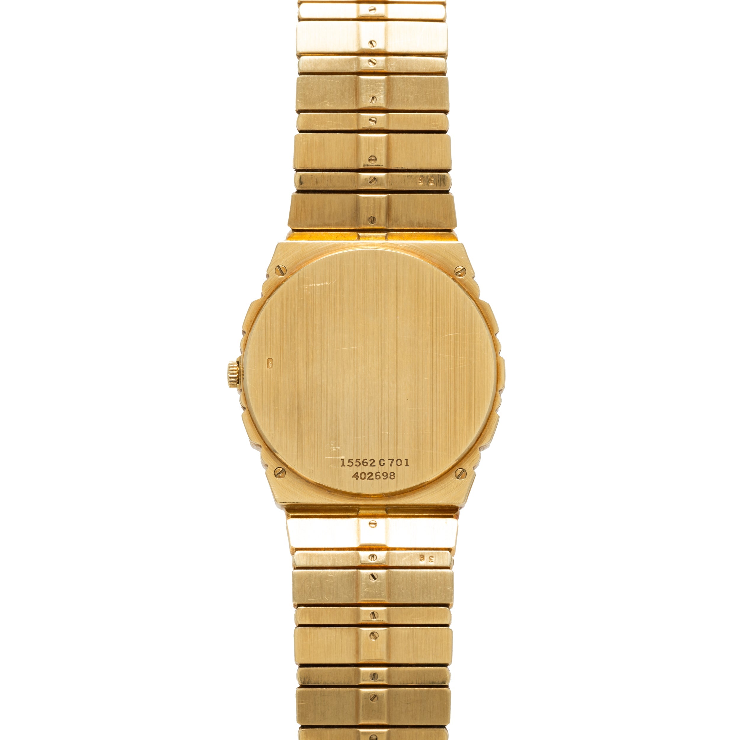 Piaget Polo Calendar watch with a brushed metal finish, viewed from the back, displaying serial numbers on the case.