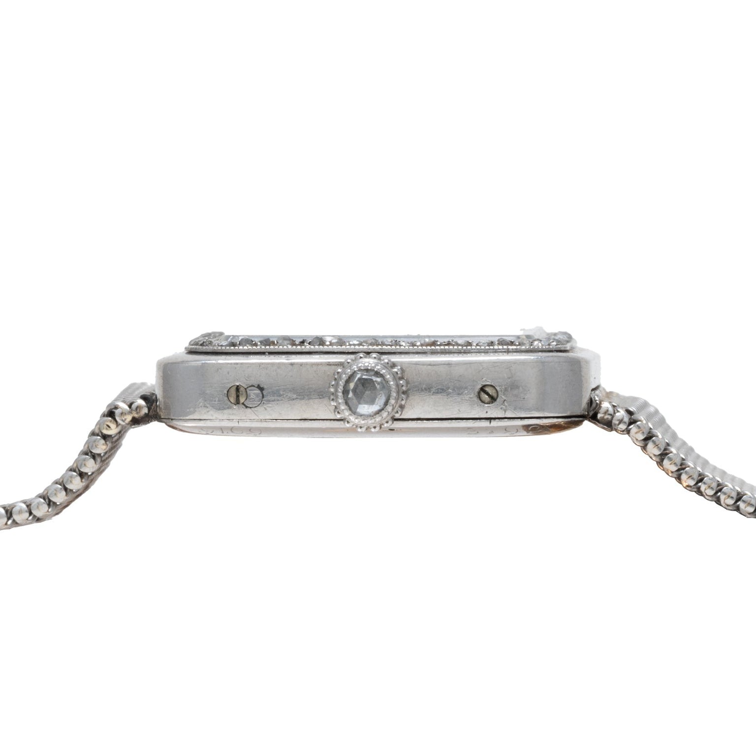 Side view of the Cartier Santos Platinum wristwatch featuring a silver metal band and a round crown.