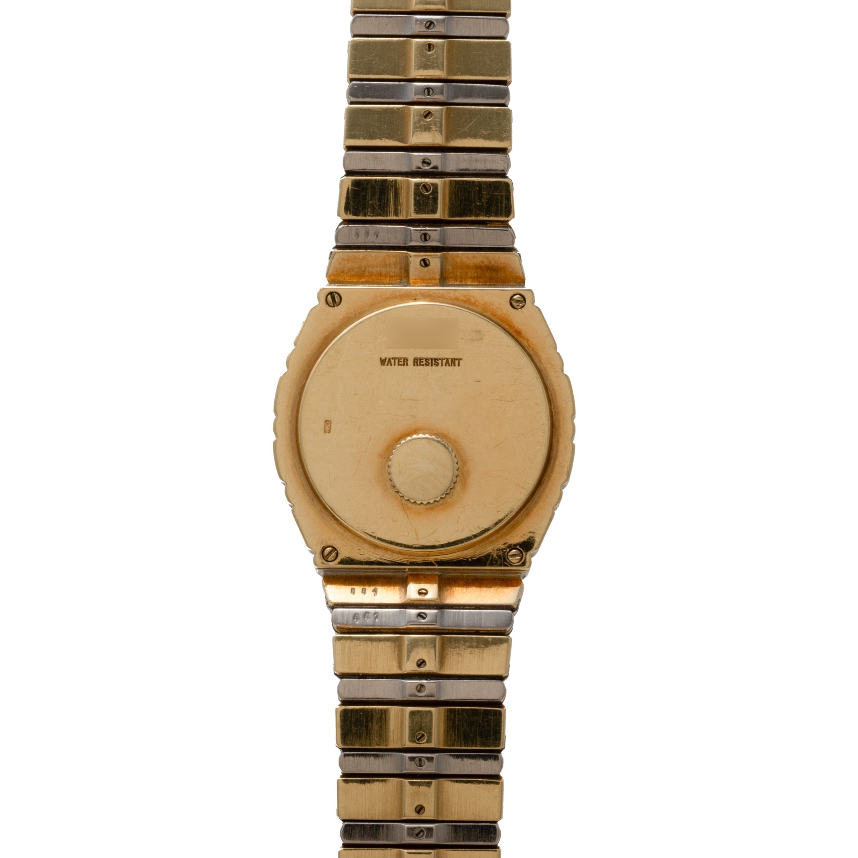 The Piaget Polo Two-Tone wristwatch is shown from the back, featuring a metal band and displaying the WATER RESISTANT text.