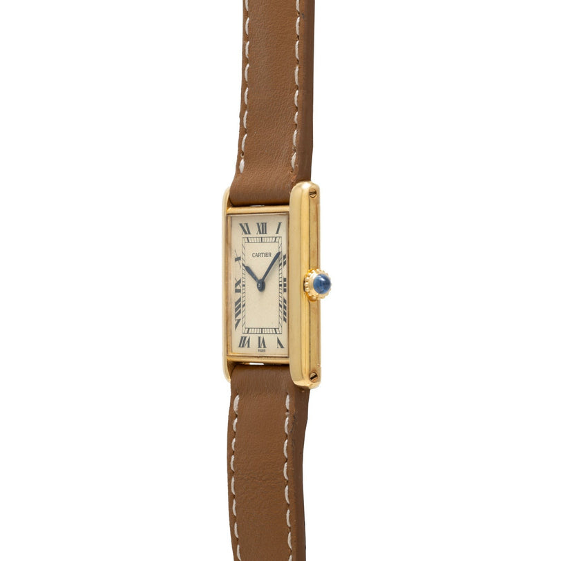 Cartier Tank Louis rectangular watch featuring a brown leather strap and Roman numerals on a white dial, side view.
