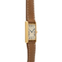 A Cartier Tank Louis gold wristwatch featuring a brown leather strap and Roman numeral hour markers.