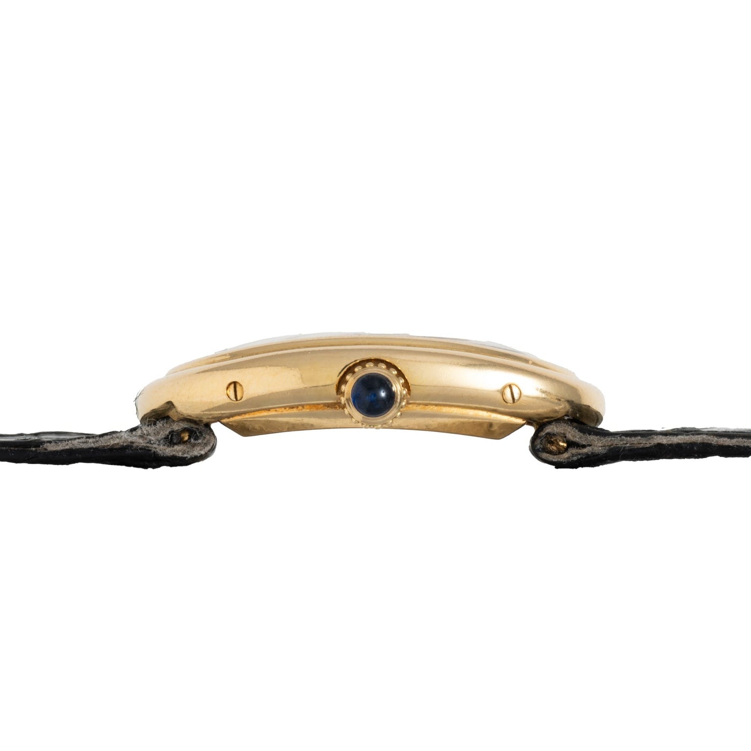 Side view of the Cartier Baignoire gold wristwatch case, featuring a blue jewel crown and a black fabric strap.