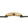 Side view of the Cartier Baignoire gold wristwatch case, featuring a blue jewel crown and a black fabric strap.