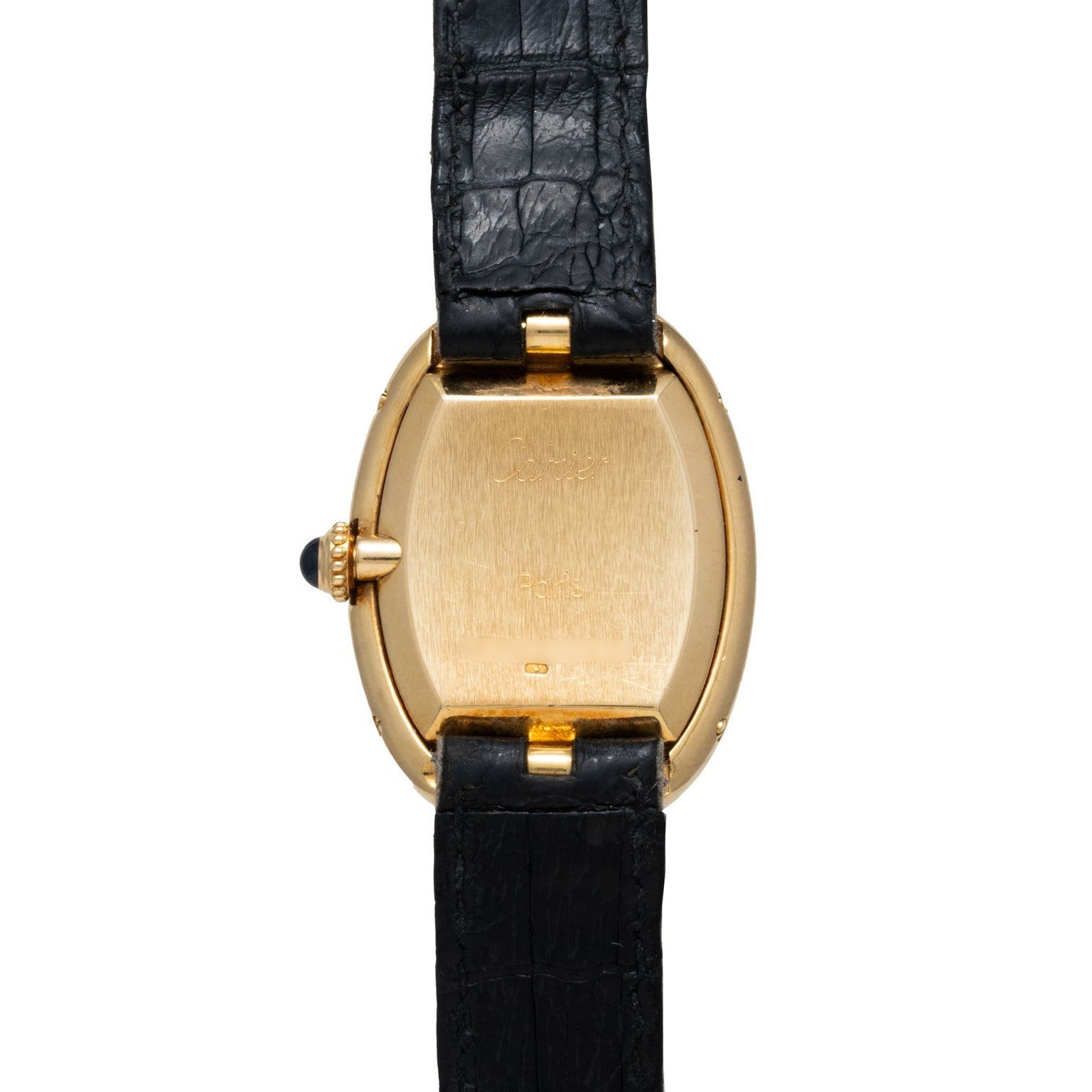 The Cartier Baignoire wristwatch features a gold case and a black leather strap, shown from the back to highlight the clasp and crown.