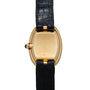 The Cartier Baignoire wristwatch features a gold case and a black leather strap, shown from the back to highlight the clasp and crown.