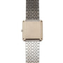 The Piaget Onyx Diamond Dress Watch features a silver metal design with a square face, shown from the back and accented by a patterned metallic band.