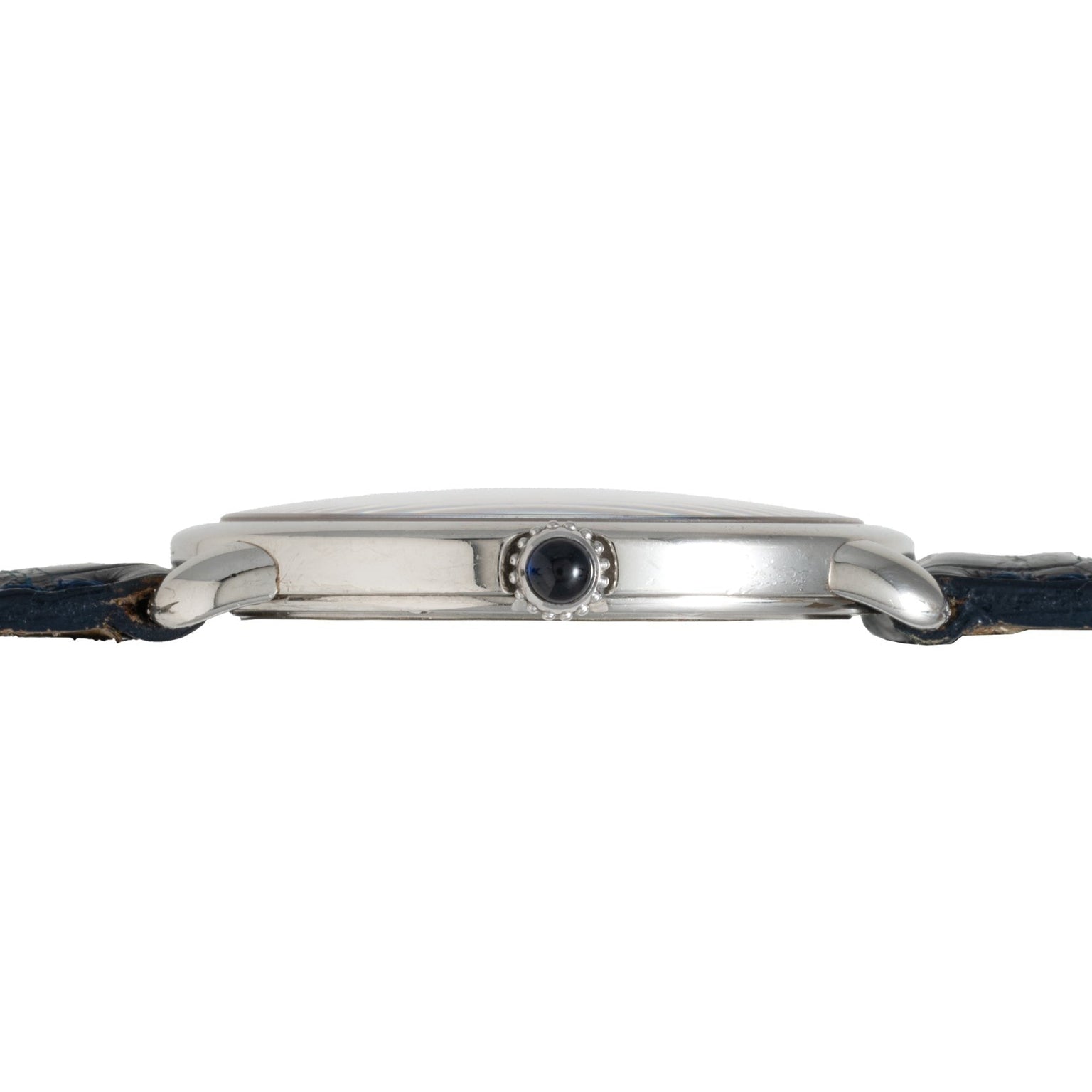 Side view of the Cartier Vendome Ronde Louis wristwatch featuring a silver case, black crown, and a worn dark leather strap.
