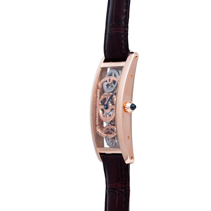 The Cartier Tank Cintreé Skeleton is a luxury watch featuring a transparent curved face, rose gold case, and dark leather strap, shown from the side.