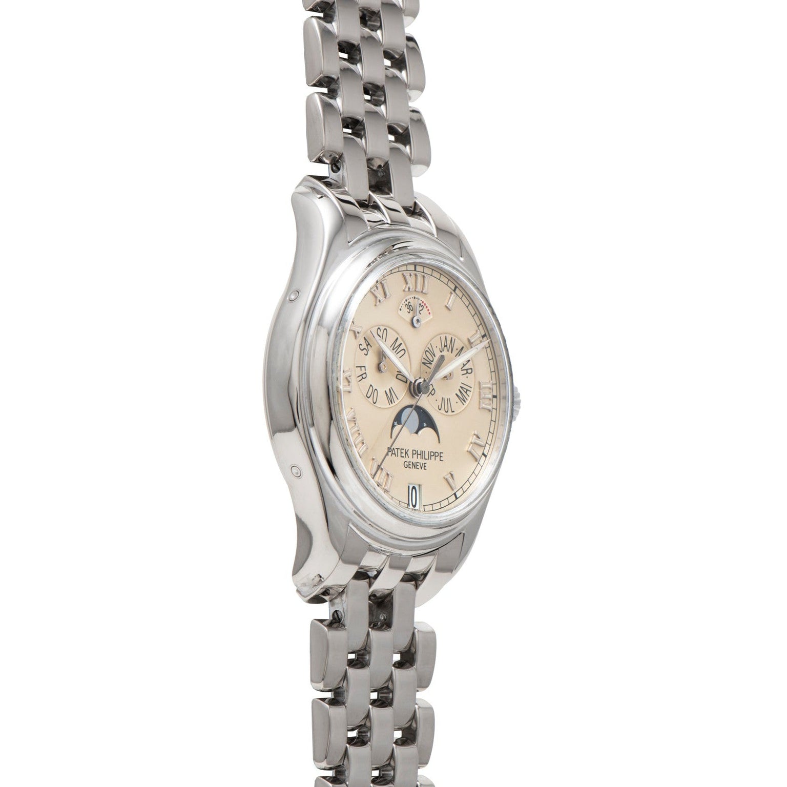 The Patek Philippe Annual Calendar wristwatch features a silver case, beige dial with Roman numerals, and a linked metal band, displayed at an angle.