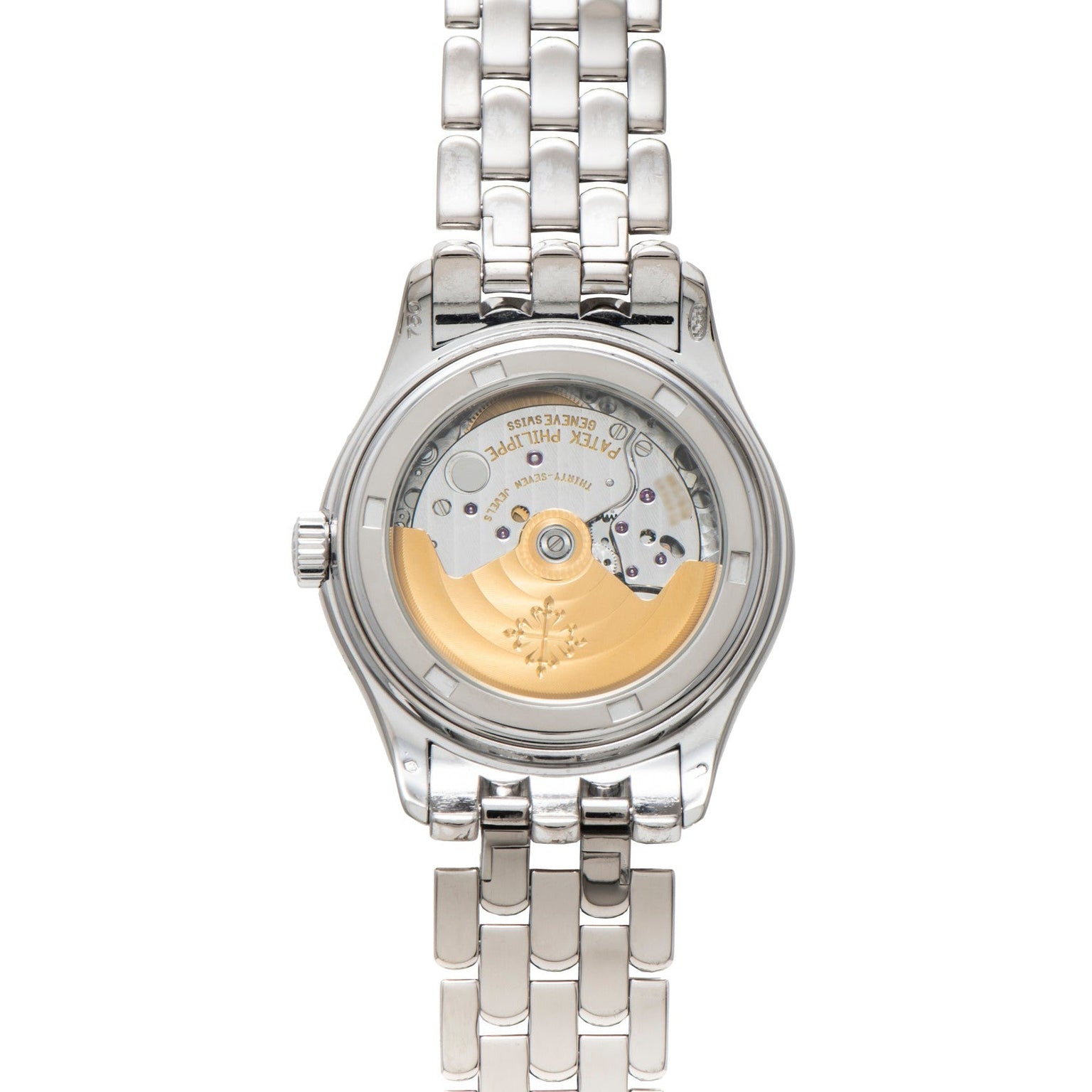 The Patek Philippe Annual Calendar wristwatch features a silver case with an open back, revealing its intricate inner gears and a gold rotor.
