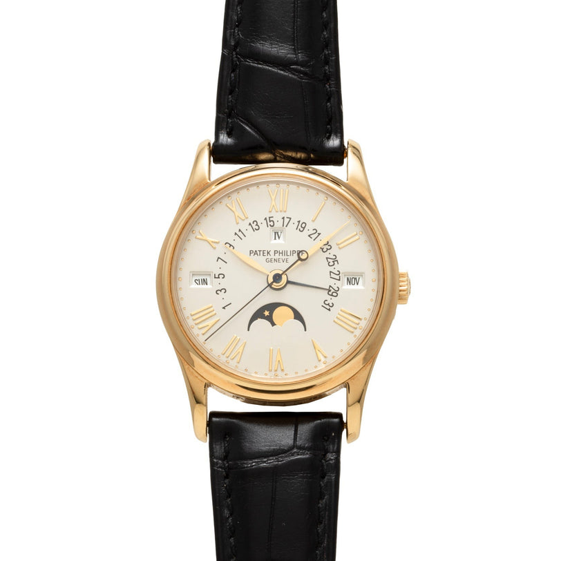 Patek Philippe Retrograde Perpetual Calendar wristwatch featuring a black leather strap, Roman numerals, and moon phase display.