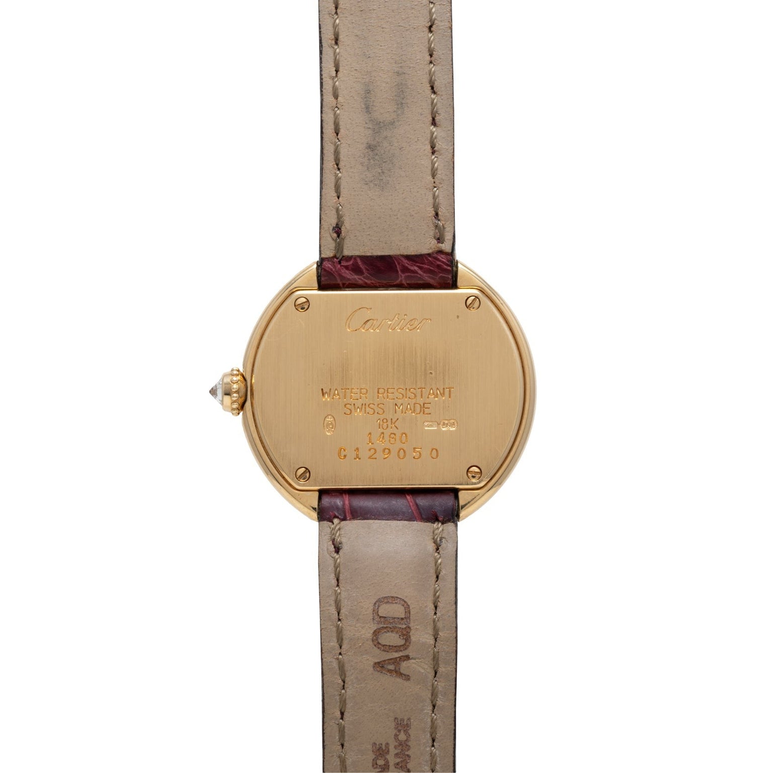 Back of the Cartier Ellipse wristwatch with gold case and brown leather strap, featuring engraved details.