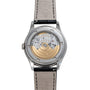 Back view of the Patek Philippe Annual Calendar Moonphase watch, featuring its exposed mechanical movement and gold rotor, complemented by a leather strap.