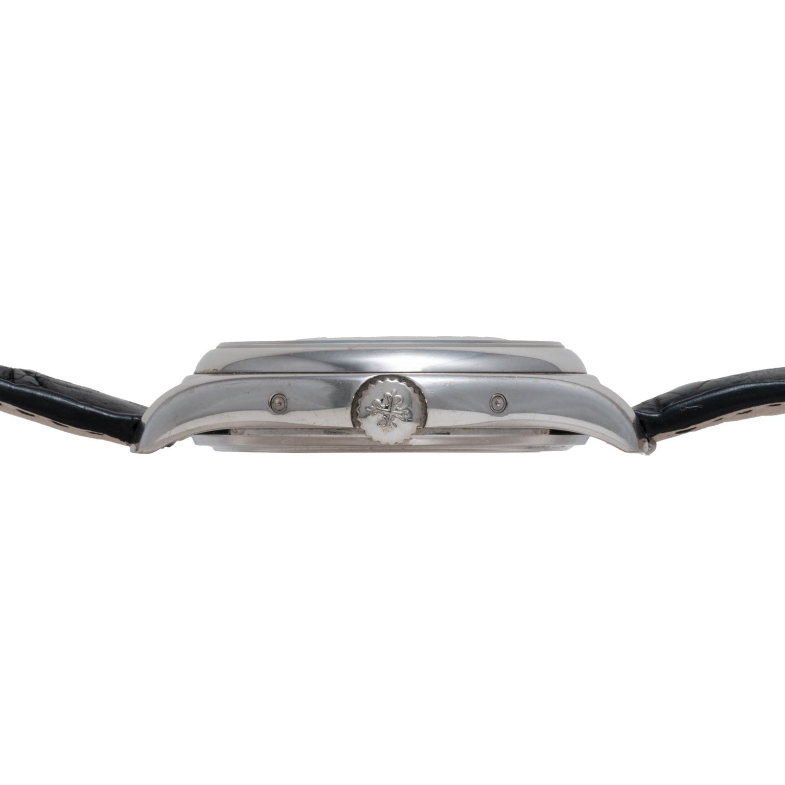 Side view of the Patek Philippe Annual Calendar Moonphase, a silver wristwatch with a black leather strap and a crown featuring an engraved emblem.