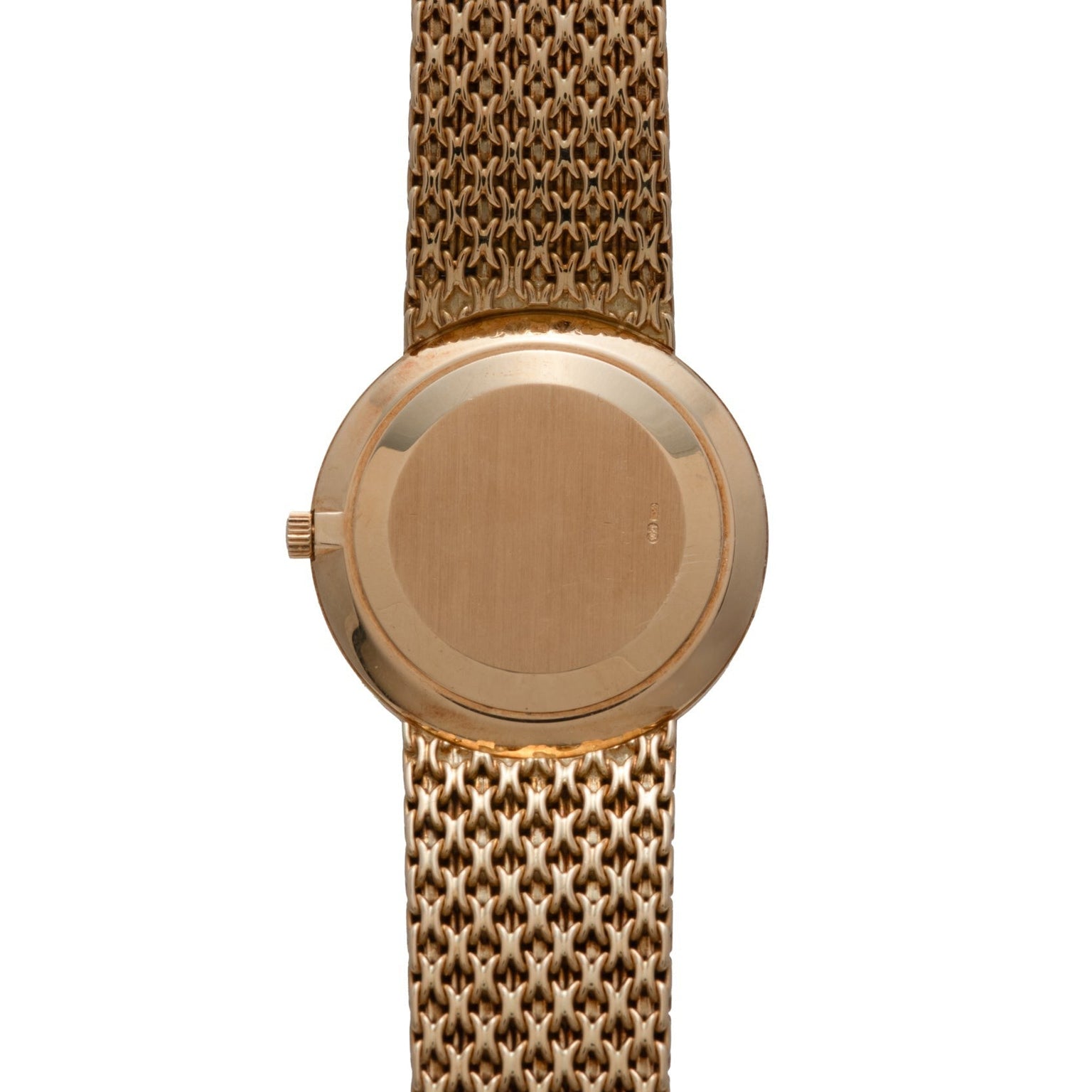 Patek Philippe Calatrava gold wristwatch featuring a round, plain back case and a textured metal bracelet, shown from the back.