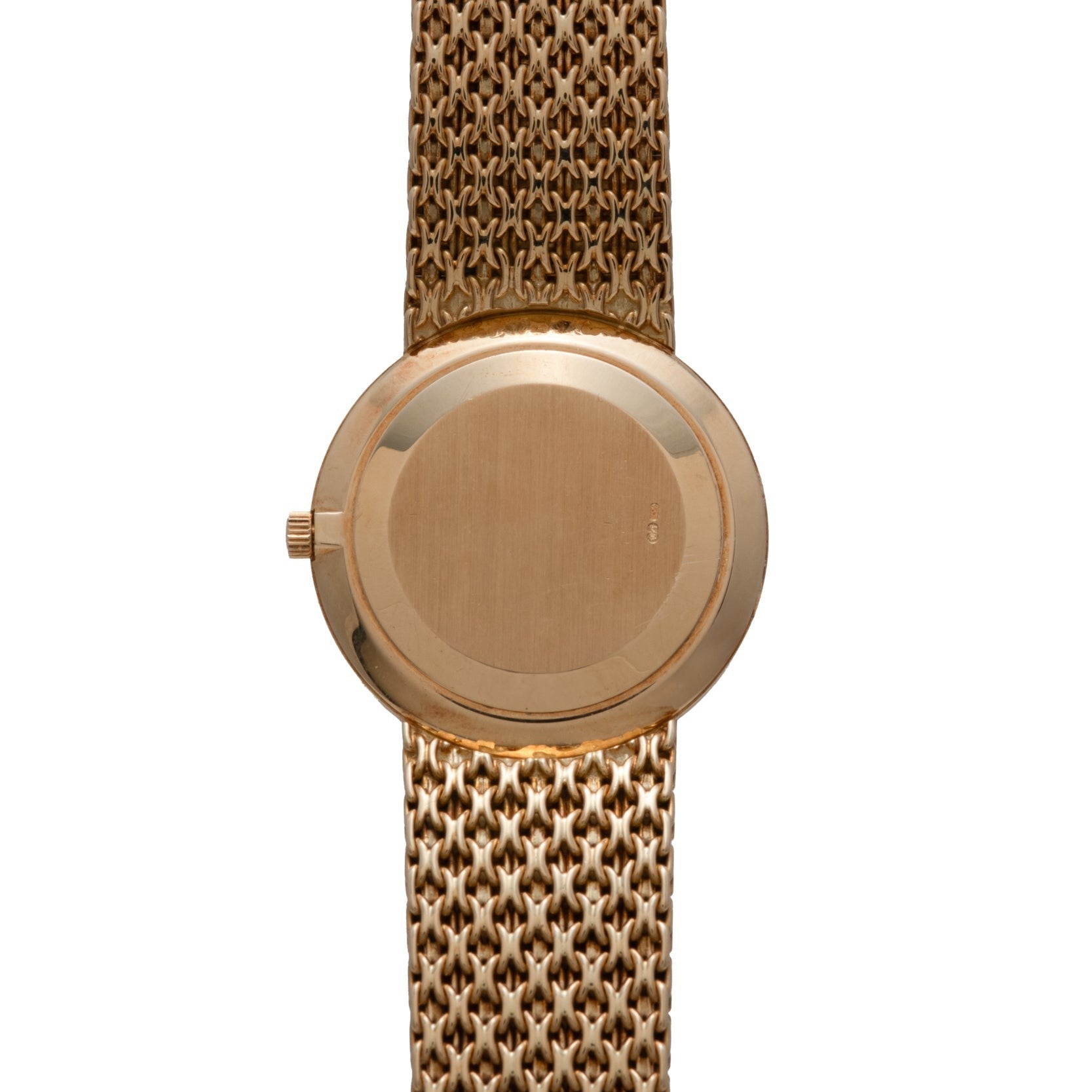 Patek Philippe Calatrava gold wristwatch featuring a round, plain back case and a textured metal bracelet, shown from the back.