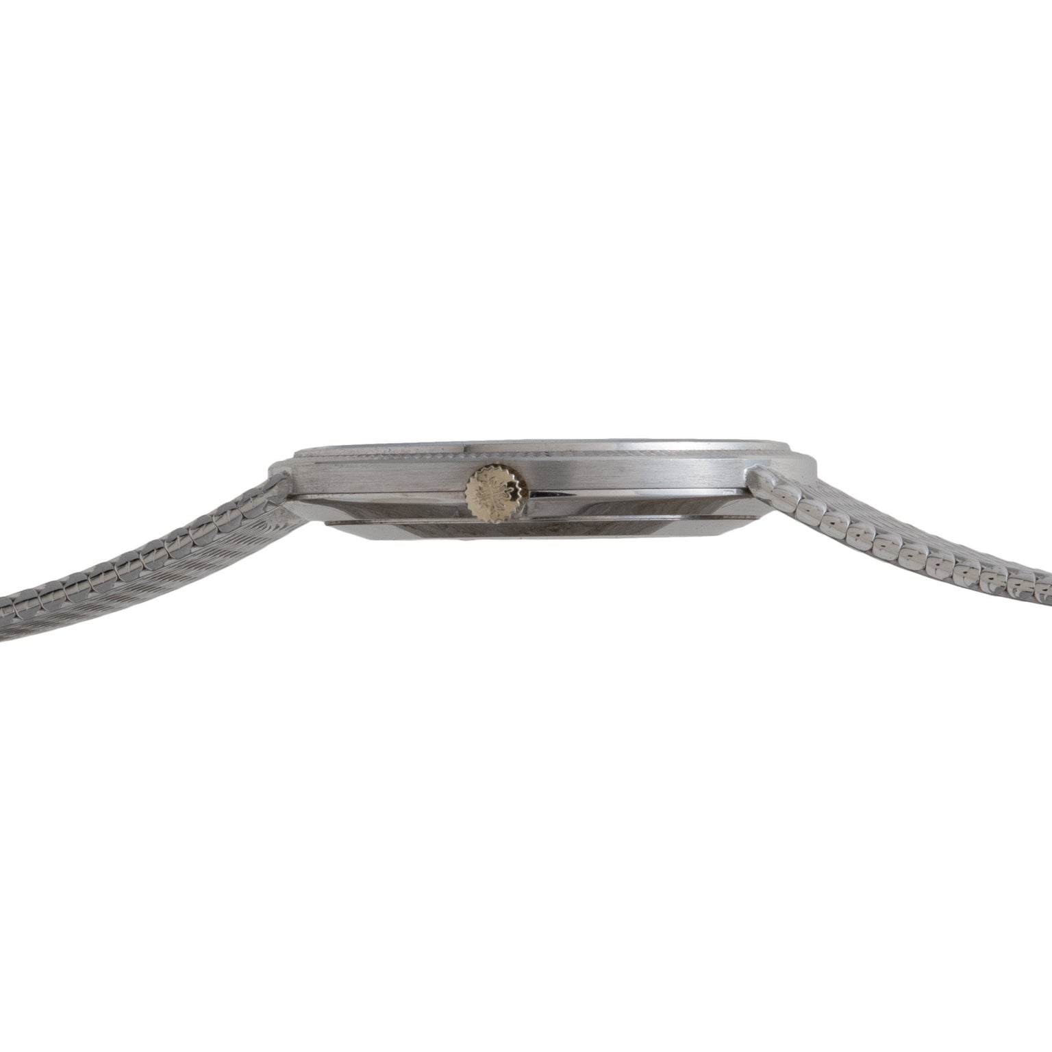 Side profile of the Patek Philippe Calatrava, a thin silver wristwatch with a textured metal band and a small round crown.