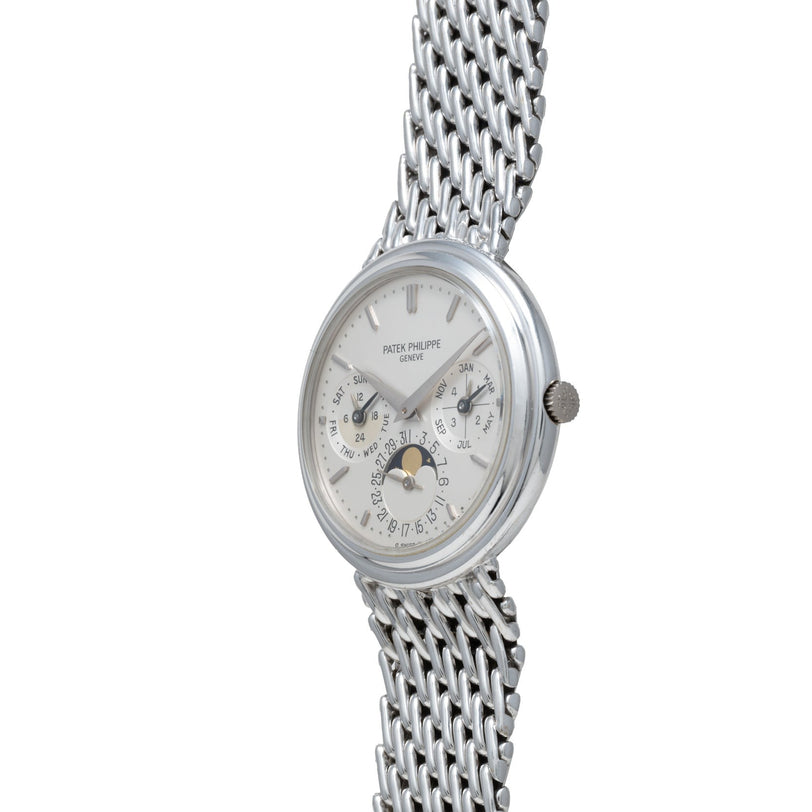 Patek Philippe Perpetual Calendar wristwatch featuring a silver mesh band and multiple dials, including a moon phase display.
