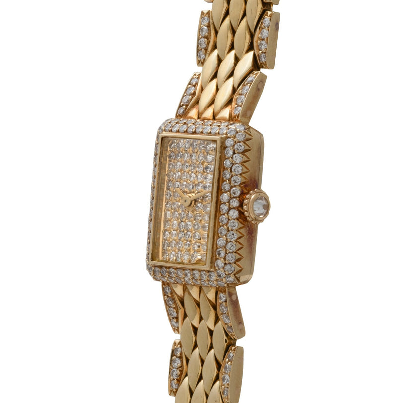 The Cartier Tank Mini Diamond features a rectangular, diamond-encrusted face and band with visible watch hands and no numbers.
